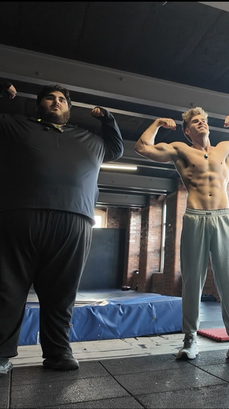 Sam and Daud flexing in the gym